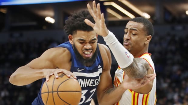 Dec 6, 2021; Minneapolis, Minnesota, USA; Minnesota Timberwolves center Karl-Anthony Towns (32) tries to get around Atlanta Hawks forward John Collins (20) in the third quarter at Target Center. Mandatory Credit: Bruce Kluckhohn-USA TODAY Sports
